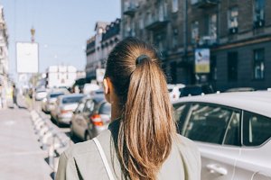 Brunette woman with straight hair in a ponytail